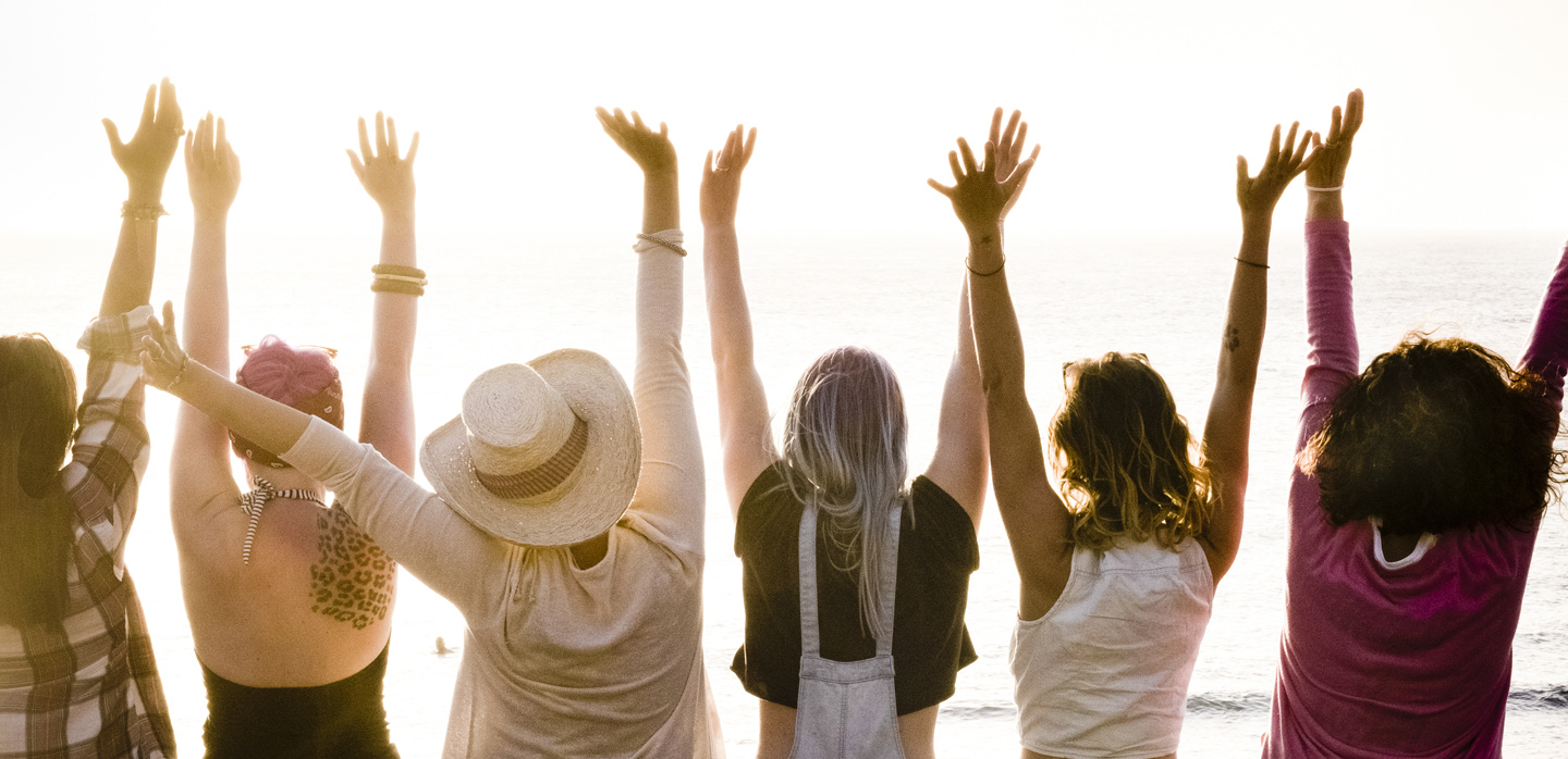 rear view of group of females friends enjoying at the sunset with ocean in background - success and satisfaction concept for nice people together with joy - friendship and vacation