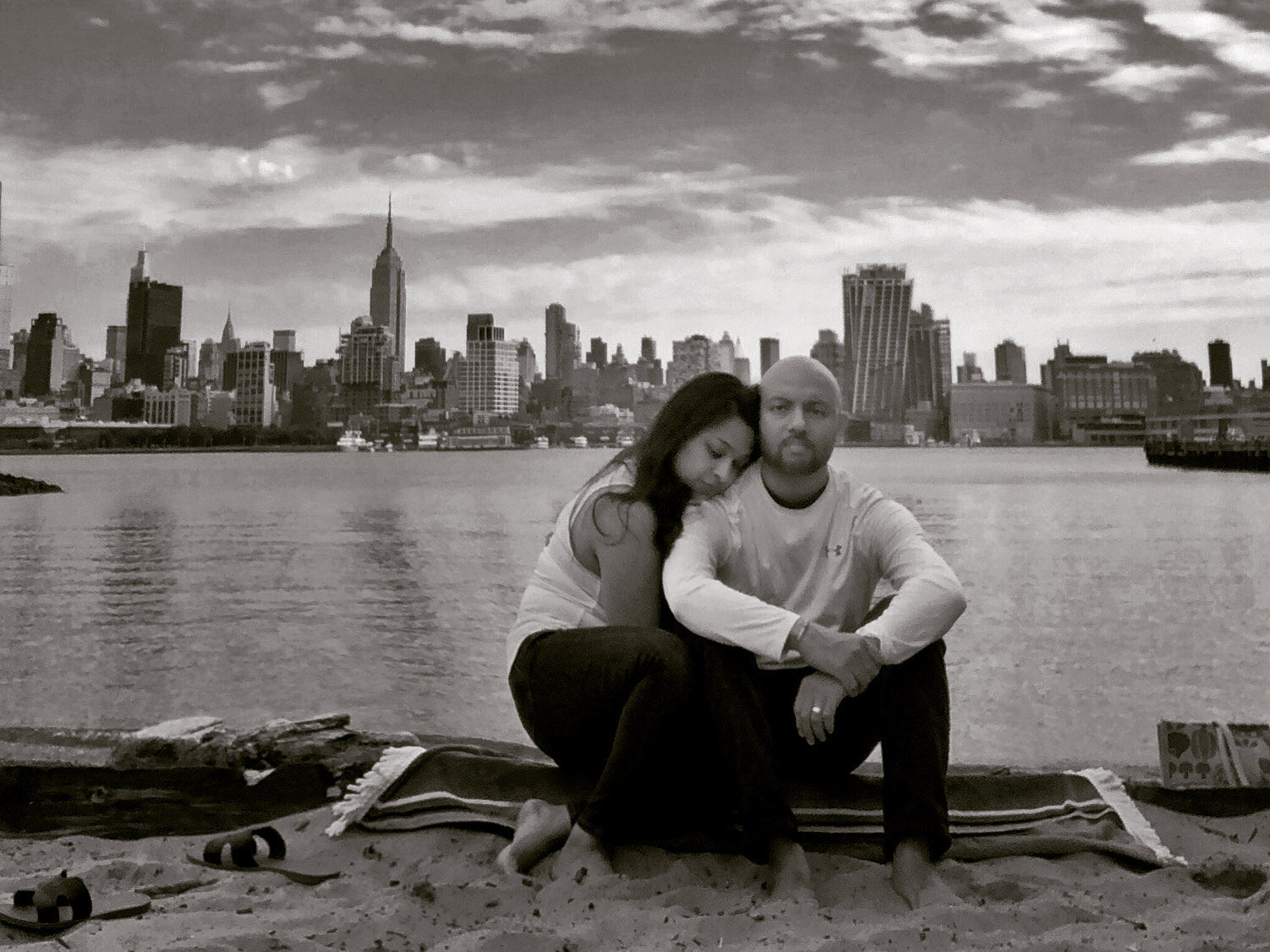 Megha and her Husband embracing at the river's edge
