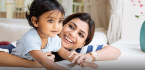 Cute little girl and her mother playing at home